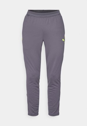 Halli sportlikud püksid, mis on valmistatud hingavast materjalist, omavad kitsenevat disaini ja kollaseid aktsente. Sisaldavad küljetaskuid ja elastset vöökoht.