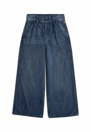Szerokie niebieskie jeansy z denimu z przednimi kieszeniami, szlufkami na pasek i zapięciem na guzik, pokazane rozłożone na białym tle.