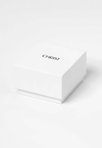 Weiße Schmuckschatulle mit glatter Matt-Oberfläche, quadratischer Form und schwarzem "CHRIST"-Logo, das auf der Oberseite aufgedruckt ist.