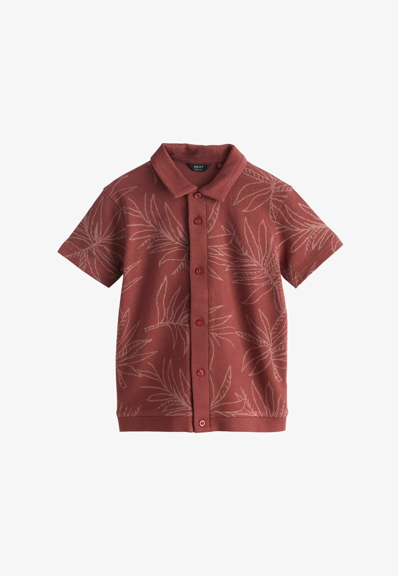 Chemise à manches courtes boutonnée en terracotta avec un motif discret de feuilles de palmier et un col classique.