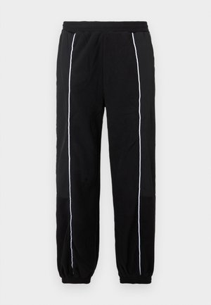 Schwarze Jogginghosen mit weißen Seitenstreifen, elastischem Bund und Bündchen. Hergestellt aus weichem, strukturiertem Stoff für Komfort und Flexibilität.