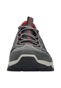 Grey athletic shoe with red accents, textile upper, contrasting stitching, and a textured rubber sole. Features woven laces and a padded collar.