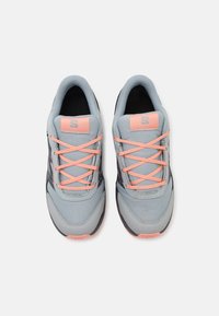 Zapatillas deportivas grises con cordones naranjas, parte superior texturizada y detalles en negro. Cuenta con un cuello acolchado y plantilla acolchada para mayor comodidad.