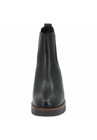Bottine en cuir noir avec bout arrondi, panneaux latéraux élastiques et semelle en caoutchouc bordée de brun. Texture lisse, design minimaliste.