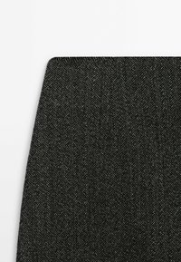 Black herringbone fabric with a subtle texture, featuring a tight weave. Edges are straight, creating a clean finish.