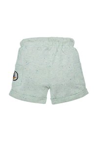 Pantaloni corti in cotone verde chiaro con orli arrotolati, caratterizzati da un motivo a pois e una tasca laterale con una toppa ricamata. Vita elasticizzata.