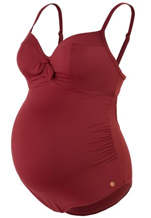 Maternity swimsuit in deep red, featuring adjustable straps, a bow accent, and gathered side details for a comfortable fit.