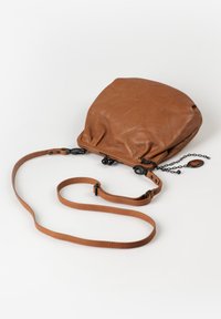 Brown leather crossbody bag with long adjustable strap and black metal chain detail on a white background.