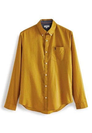 Sennepsgul langærmet knap-op skjorte med krave med knapper, hvide knapper og brystlomme med lille sort broderi.