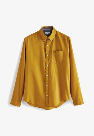 Senfgelbe Langarm-Bluse mit Knopfleiste, Button-Down-Kragen, weißen Knöpfen und Brusttasche mit kleiner schwarzer Stickerei.