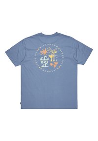 Light blue cotton t-shirt with a colorful circular graphic on the back featuring palm trees, stars, and text “Billabong Since 1973.”