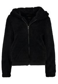 Svart, fluffig zip-up hoodie med ribbade manschetter och nederkant, som har en mjuk, plyschig textur och en stor huva.