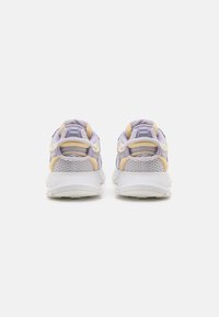 Purple and yellow athletic sneakers with mesh panels, padded collars, and a white rubber sole. Features pronounced heel and contrasting accents.