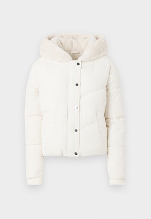 White puffer jacket featuring a faux fur-lined hood, snap-button closure, side pockets, and vertical quilted pattern for insulation.