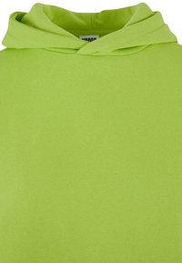 Felpa con cappuccio verde lime in morbido tessuto di cotone. Caratterizzata da un design del cappuccio classico con una texture semplice e senza cuciture.