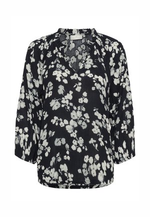 Schwarze Bluse mit weißem Blumenmuster, v-Oberteil, Dreiviertelärmel und lockerer Schnitt ausleichtem Stoff.