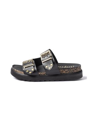 Black slip-on sandal with two adjustable gold buckles, cork-textured midsole, and thick black ridged sole, side view.