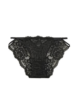 Sous-vêtements féminins en dentelle noire avec motifs floraux et fines bretelles latérales réglables sur fond blanc.