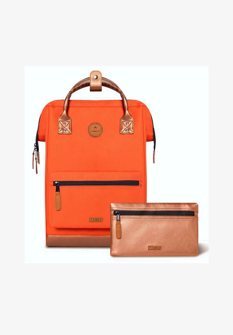 Orange canvas backpack with a copper accent handle, featuring a front zip pocket. Accompanied by a matching copper zip pouch.