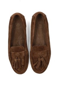 Brown suede moccasin-style loafers with tassel detailing and perforated insoles. Soft texture and rounded toe design.