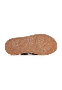 Brown rubber sole with a textured pattern; features zigzag and horizontal lines for grip; curved shape around edges.