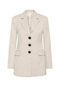 Blazer beige sur mesure en tissu léger. Caractéristiques : revers crantés, quatre boutons noirs et deux poches avant.
