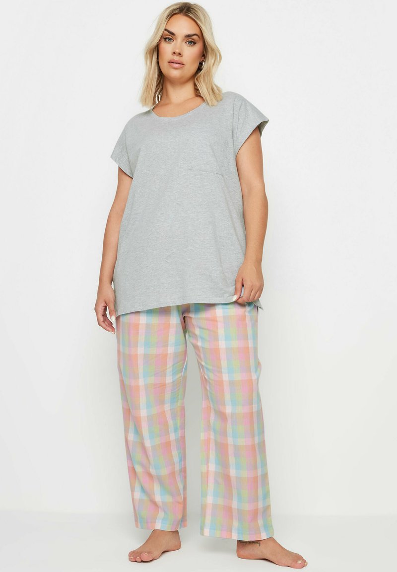 Grijze T-shirt met korte mouwen en een zak, gecombineerd met pastelkleurige geruite pyjamabroek met roze, blauwe, groene en gele vierkanten.