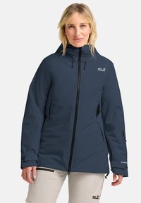 Marineblaue wasserdichte Jacke mit verstellbarem Kapuze, Frontreißverschluss und Seitentaschen. Mit Logo auf der linken Brust und strukturierten Ärmelabschlüssen.