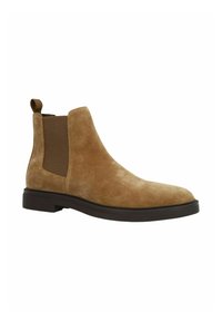 Tan suède Chelsea-boots met elastische zijkanten, een aantrektab, en een dikke bruine zool. Gladde textuur met een ronde neus.