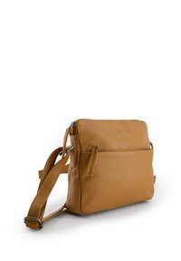 Tan leather crossbody bag with a textured finish, featuring a zippered top, a front pocket, and an adjustable strap.