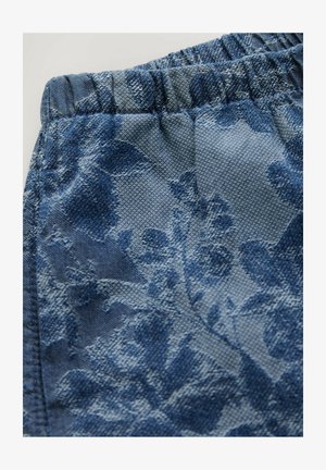 Blue elastic waistband shorts with a textured floral pattern. The fabric features a woven design in varying shades of blue.
