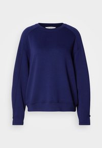 Tengerészkék sweatshirt, puha anyagból készült, kerek nyakkivágással, hosszú raglán ujjakkal és gombos díszítéssel a mandzsettákon.