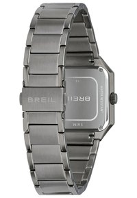 Montre en acier inoxydable argenté avec un fini brossé. Boîtier rectangulaire, étanche jusqu'à 50m, avec une fermeture portant le nom de la marque "Breil".