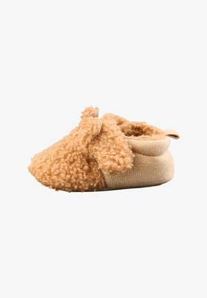 Soft, beige baby shoe with curly plush fabric and small floppy ears resembling a puppy, designed for comfort and warmth.