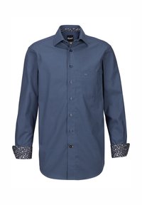 Camicia a bottone in tessuto blu scuro con maniche lunghe. Polsini e colletto foderati con un notevole motivo floreale, con dettagli di taschino sul petto.