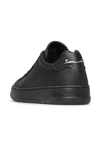 Sneaker in pelle nera con finitura testurizzata, punta arrotondata, suola in gomma e branding discreto sul tallone, tutto con un design minimalista.