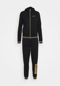Survêtement Puma noir pour femmes avec sweat à capuche zippé et pantalon, avec des accents dorés et le logo Puma sur la poitrine et la jambe.