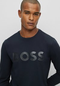 BOSS Togn Long Sleeve T Shirt in Navy & Gold I BOSS I Norton Barrie