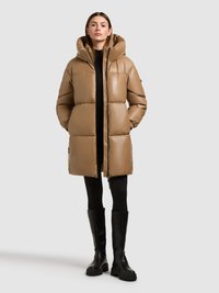 Brown puffer coat with a large hood, quilted design, and zippered front. Worn over a black outfit, paired with knee-high black boots.