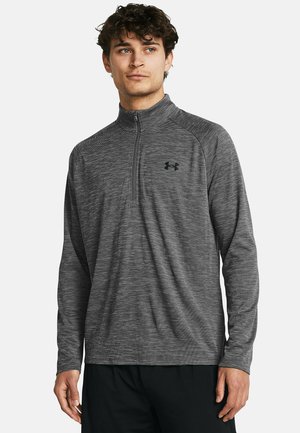 Gray quarter-zip athletic shirt with a subtle striped pattern, long sleeves, and a smooth, flexible fabric. Black logo on the chest.