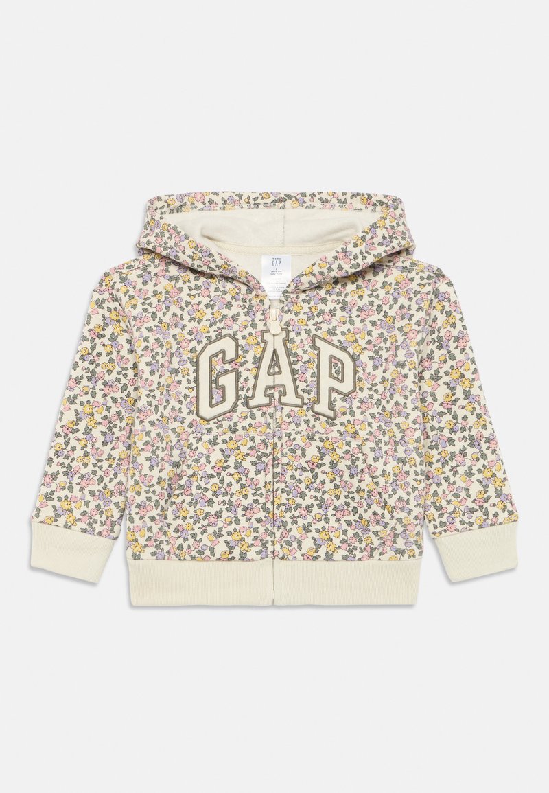Cremfarbener Kapuzenpullover mit Blumenmuster und gelben, rosa und grünen Akzenten. Mit einem „GAP“-Logo auf der Vorderseite und einem weichen, strukturierten Innenfutter.