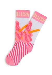 Chaussettes roses et blanches avec un motif floral, des accents orange et des rayures horizontales au niveau des orteils. Texte "BLUSH" en jaune en haut.
