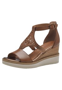 Bruine wig sandal met uitsnijdingen, synthetisch bovenwerk, open teen, verstelbare enkelband en textuurplatteauzool.