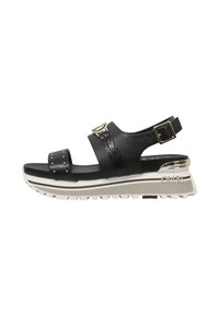 Sandalo nero con due cinturini, uno dei quali presenta borchie. Cintura accentuata texture. Presenta una suola a zeppa con una base bianca e grigia, logo inciso.