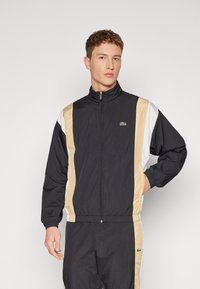 Lacoste - SHOWERPROOF TRACKJACKET - Summer jacket - black/croissant flour Thumbnail Image 1