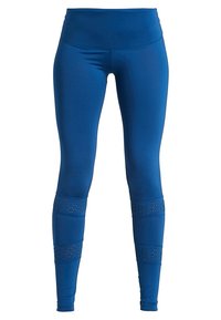 Blå leggings med hög midja, tillverkade av ett mjukt tyg. Har utskärningar vid underbenet för ökad andningsförmåga.