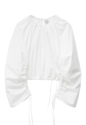 White cropped blouse with long puffed sleeves, gathered elastic neckline, and adjustable ruching with ties on the sides and sleeves.