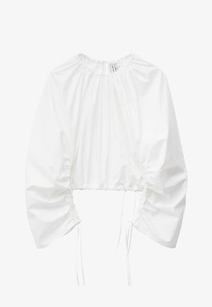 White cropped blouse with long puffed sleeves, gathered elastic neckline, and adjustable ruching with ties on the sides and sleeves.