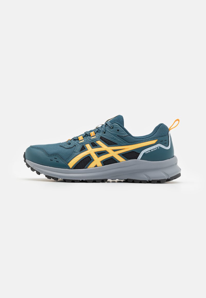 Chaussure de sport teal et noire avec des accents orange. Comprend des matériaux en mesh et synthétiques, une semelle en caoutchouc épaisse avec traction et une languette de tirage.