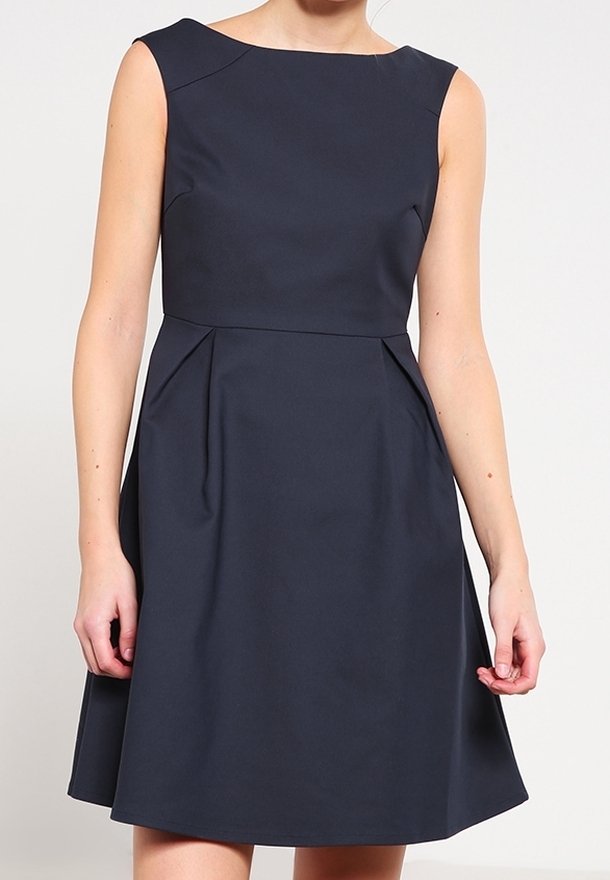 Snygg marinblå klänning med båt-nacke och ärmstycken; utsvängd kjol med horisontella veck vid midjan; slät, enhetlig tyg.